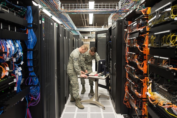 Tech. Sgt. David Mooers and Senior Airman Mario Lunato, 2nd System Operations Squadron system administrators, access one of the core servers in the 557th Weather Wing (WW) enterprise at Offutt Air Force Base, Nebraska, April 27, 2018. The 557th WW’s Host Based Security System monitors the servers’ overall health and provides security features such as firewalls and antivirus scans that are tailored for the specialized weather systems. (U.S. Air Force photo by Paul Shirk)