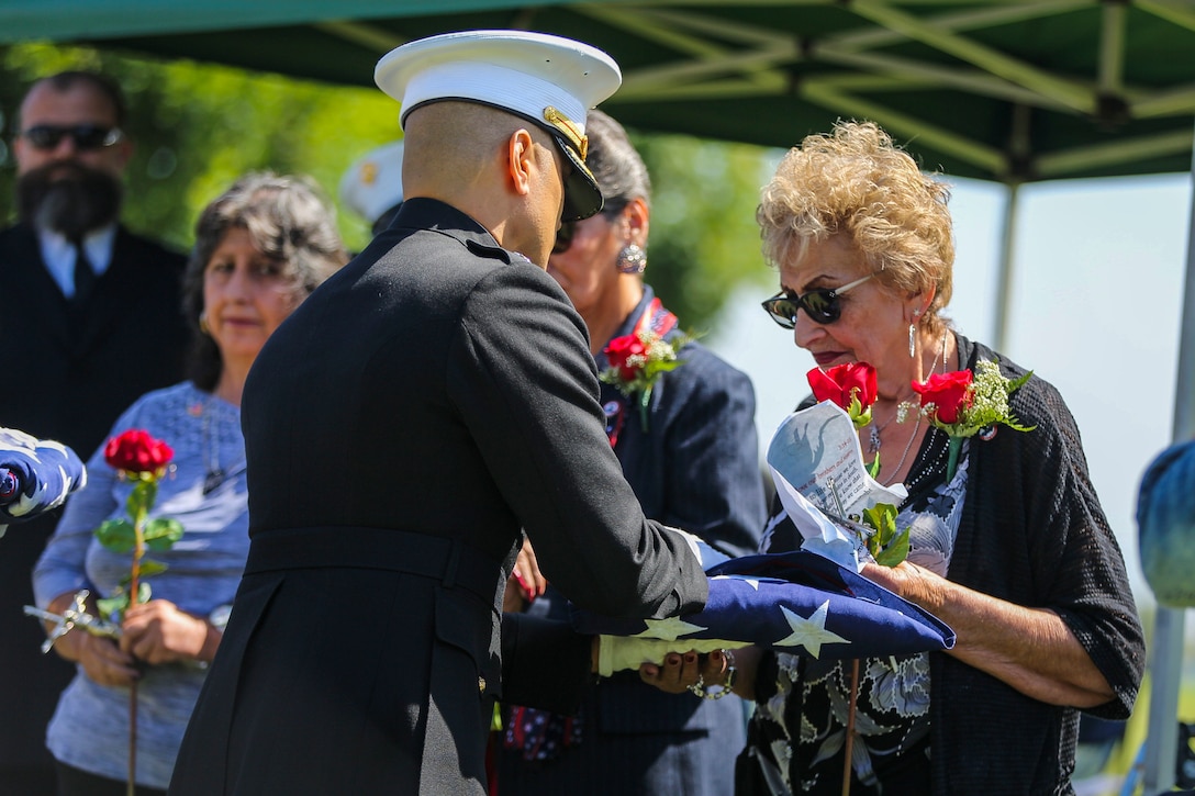 The family of Pfc. Roger Gonzales recive American flags during his funeral service at the Green Hill Mortuary and Memorial Chaple, Rancho Palos Verdes, California, Sept. 21, 2018.