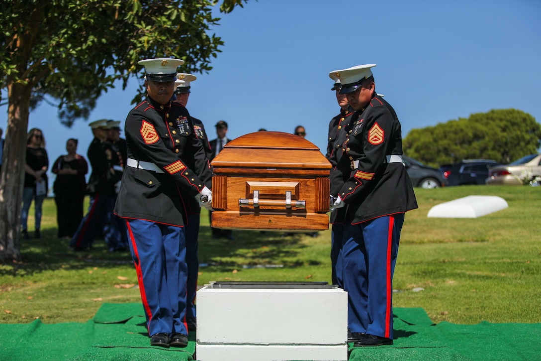 The family of Pfc. Roger Gonzales recive American flags during his funeral service at the Green Hill Mortuary and Memorial Chaple, Rancho Palos Verdes, California, Sept. 21, 2018.