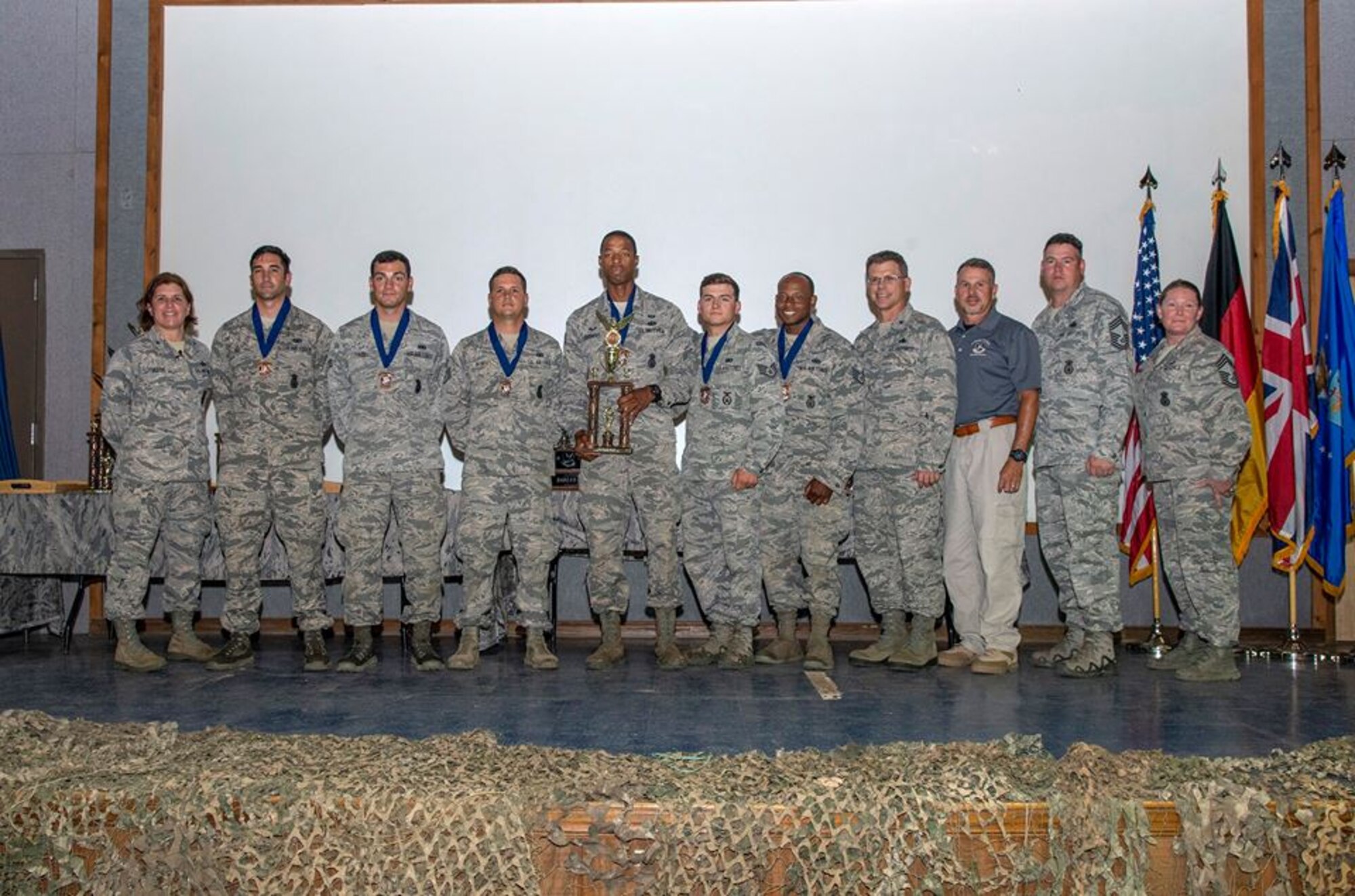 The Air Mobility Command team receives the 3rd place medals and trophy for combat endurance during the 2018 Defender Challenge award ceremony at Joint Base San Antonio, Texas, Sept. 13, 2018. Teams were scored on their completion of a gruelling relay of calisthenics to increase their physiological stress level prior to firing at a target with their weapon. (Courtesy Photo)