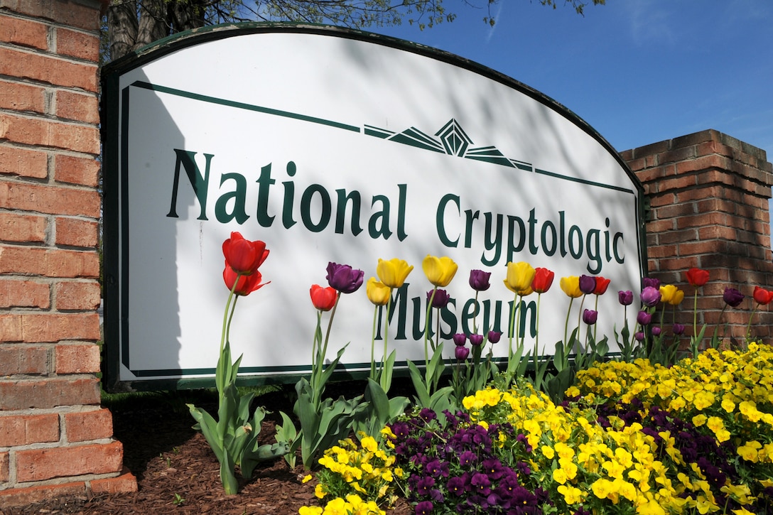 National Cryptologic Museum Sign with spring flowers in front of it.
