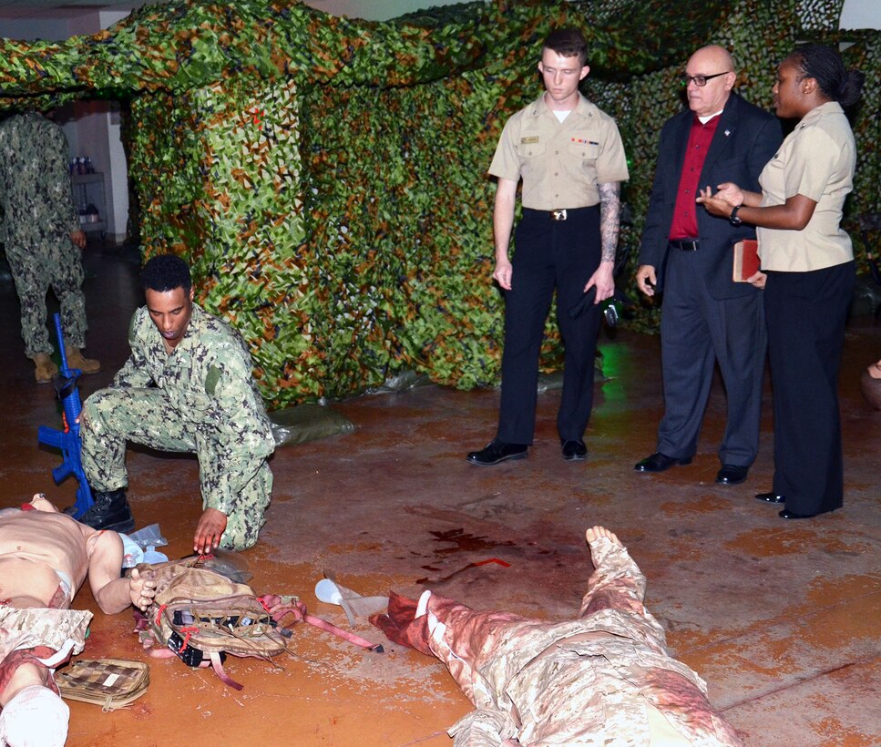 Retired Master Chief James Parlier observes a student conduct mass casualty training in the Hospital Corpsman Basic program at the Medical Education and Training Campus at Joint Base San Antonio-Fort Sam Houston Sept. 21. Parlier is joined by his great nephew, Petty Officer 3rd Class Shelton Carter (left), and HCB instructor Petty Officer 1st Class Renata Williams (right).