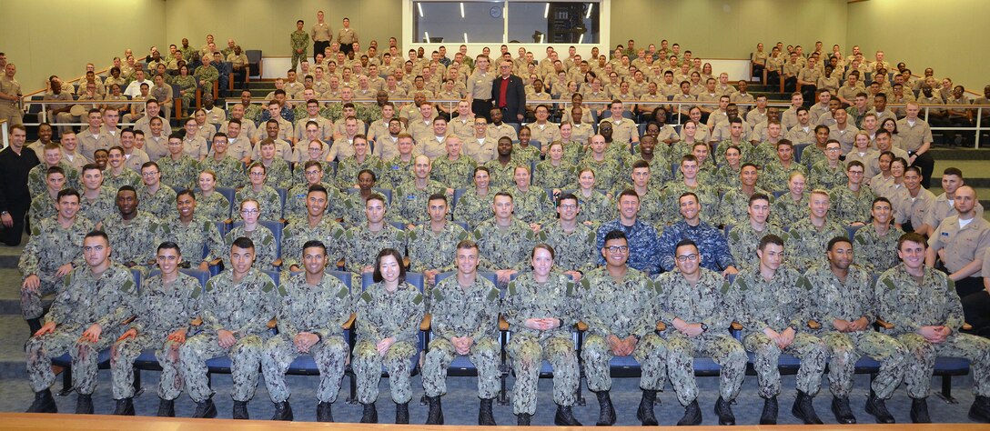 Retired Master Chief James Parlier (far back center) poses with Navy students and staff in the Hospital Corpsman Basic program at the Medical Education and Training Campus at Joint Base San Antonio-Fort Sam Houston Sept. 21.