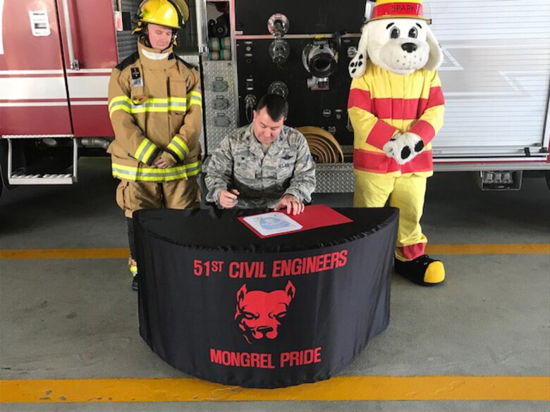 Col. William Betts, 51st Fighter Wing commander, signs the annual Fire Prevention Week proclamation on Osan Air Base, Republic of Korea, Sept. 27, 2018.