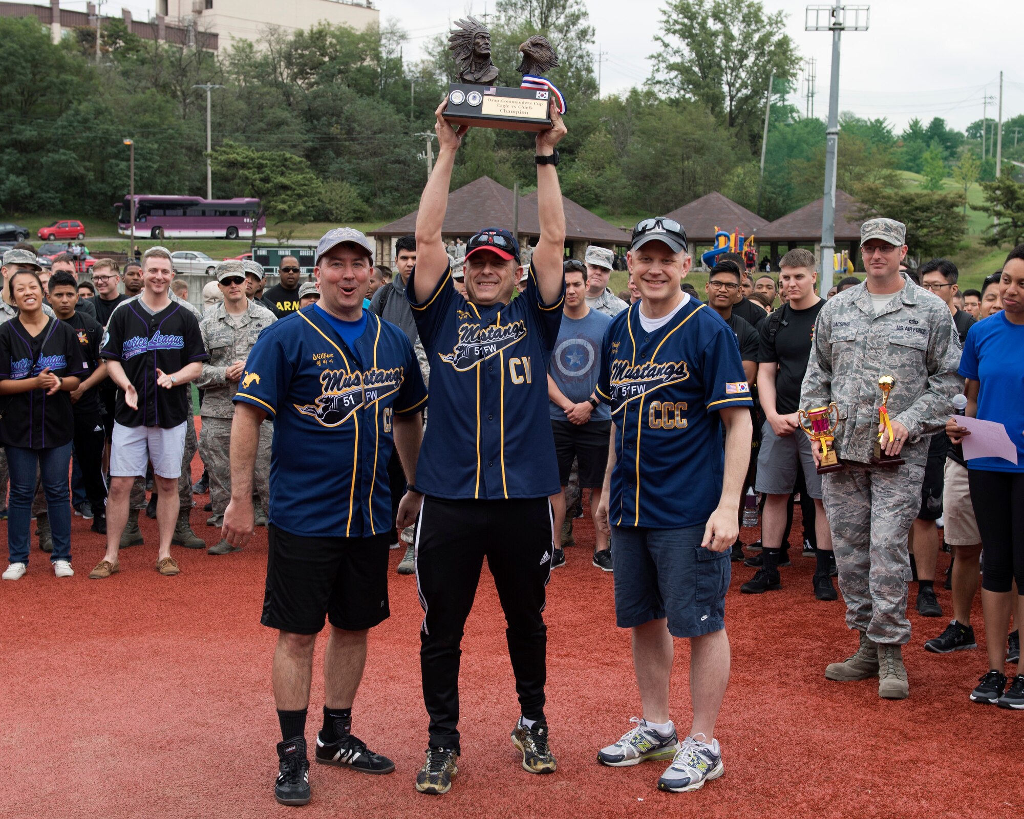 U.S. Air Force Col. Jesse Fiedel, 51st Fighter Wing vice commander, hoists the annual Osan Commander’s Cup softball championship trophy at Osan Air Base, Republic of Korea, Sept. 28, 2018 after the Eagle vs. Chiefs softball game. The colonels beat the chiefs by a score of 10-2. (U.S. Air Force photo by Staff Sgt. Sergio A. Gamboa)