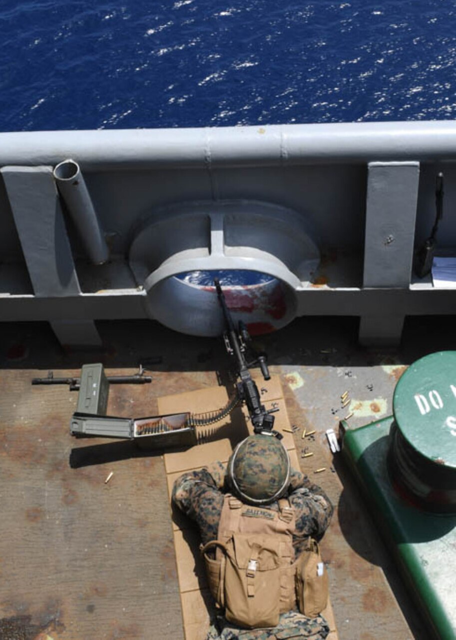 SOUTH CHINA SEA (Sept 27, 2018) Lance Cpl. Michael Battion, assigned to the 31st Marine Expeditionary Unit (MEU), Battalion Landing Team, 2nd Battalion, 5th Marines, shoots a M240B machine gun as another Marine observes during a Defense of the Amphibious Task Force (DATF) drill aboard the amphibious assault ship USS Wasp (LHD 1). As part of the DATF, the Wasp Amphibious Ready Group (ARG), 31st Marine Expeditionary Unit (MEU) team, assumed a security posture, to simulate traveling through potentially dangerous waters. Wasp, flagship of the Wasp ARG, with embarked 31st MEU, is operating in the Indo-Pacific region to enhance interoperability with partners and serve as a ready-response force for any type of contingency.