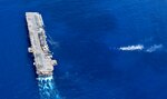 SOUTH CHINA SEA (Sept. 27, 2018) - The amphibious assault ship USS Wasp (LHD 1) performs maneuvers as Sailors and Marines, assigned to the 31st Marine Expeditionary Unit (MEU), fire weapons, including Light Armored Vehicles, at a target during a Defense of the Amphibious Task Force (DATF) drill. As part of the DATF, the Wasp Amphibious Ready Group (ARG), 31st MEU team, assumed a security posture, to simulate traveling through potentially dangerous waters. Wasp, flagship of the Wasp ARG, with embarked 31st MEU, is operating in the Indo-Pacific region to enhance interoperability with partners and serve as a ready-response force for any type of contingency.
