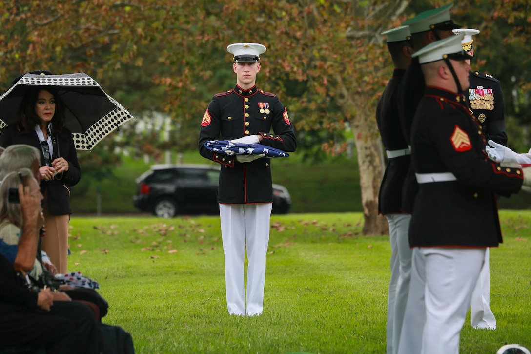 Corporal Justin M. Perry, flag bearer, Marine Barracks Washington D.C., holds the National Flag during a full honors funeral for three formerly unaccounted for Vietnam veterans at Arlington National Cemetery, Arlington, Va., Sept. 27, 2018. Capt. John A. House II, Cpl. Glyn L. Runnels, Jr. and Lance Cpl. John D. Killen III were accounted for on Dec. 22, 2015 and buried together in Arlington. The Marines died when their CH-64A Sea Knight helicopter was struck by enemy fire and crashed, June 30, 1967. House, who piloted the helicopter, was attempting to insert eight members of Company A, 3rd Reconnaissance Battalion, 3rd Marine Division, into hostile territory in Thau Thien-Hue Province, Vietnam, when enemy forces attacked from a surrounding tree line. Lance Cpl. Merlin R. Allen and Navy Hospital Corpsman Michael B. Judd also died during the crash and were individually identified in 2013. (U.S. Marine Corps photo by Sgt. Robert Knapp/Released)
