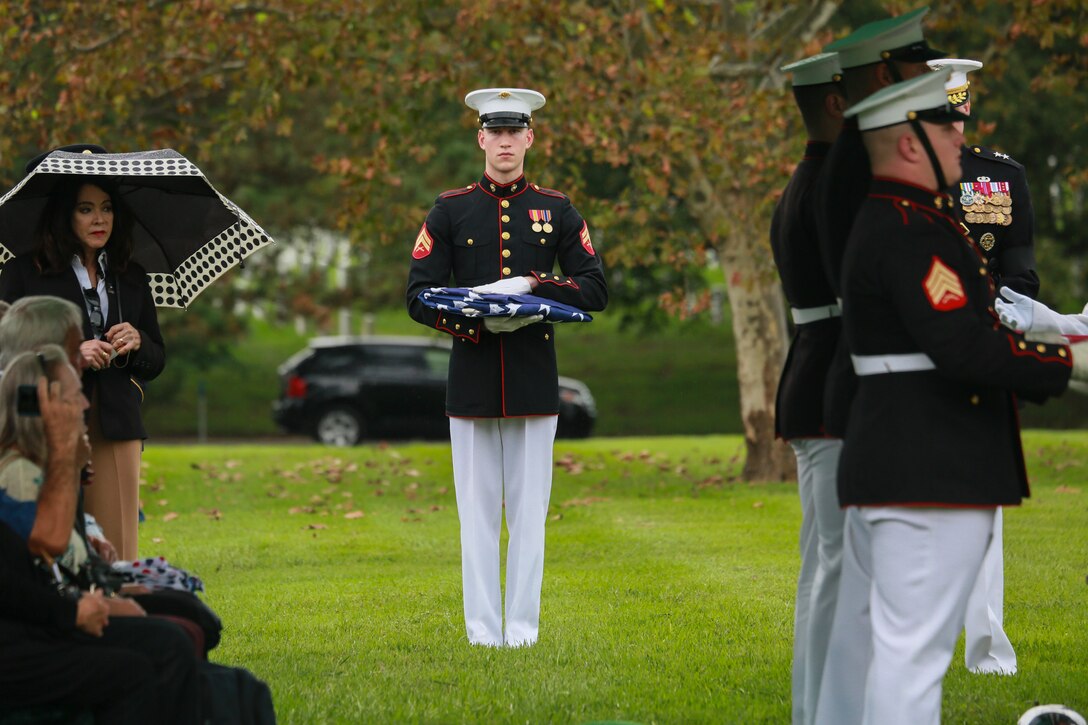 Corporal Justin M. Perry, flag bearer, Marine Barracks Washington D.C., holds the National Flag during a full honors funeral for three formerly unaccounted for Vietnam veterans at Arlington National Cemetery, Arlington, Va., Sept. 27, 2018.