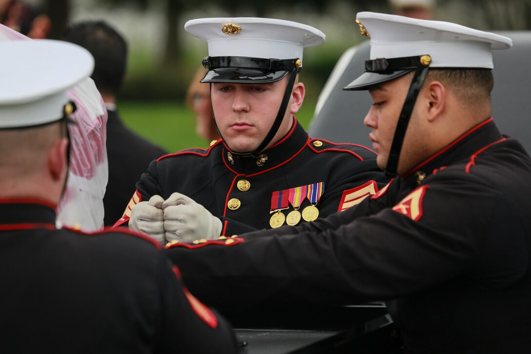 Marine Corps Body Bearers, Bravo Company, Marine Barracks Washington D.C., prepare to secure a casket during a full honors funeral for three formerly unaccounted for Vietnam veterans at Arlington National Cemetery, Arlington, Va., Sept. 27, 2018. Capt. John A. House II, Cpl. Glyn L. Runnels, Jr. and Lance Cpl. John D. Killen III were accounted for on Dec. 22, 2015 and buried together in Arlington. The Marines died when their CH-64A Sea Knight helicopter was struck by enemy fire and crashed, June 30, 1967. House, who piloted the helicopter, was attempting to insert eight members of Company A, 3rd Reconnaissance Battalion, 3rd Marine Division, into hostile territory in Thau Thien-Hue Province, Vietnam, when enemy forces attacked from a surrounding tree line. Lance Cpl. Merlin R. Allen and Navy Hospital Corpsman Michael B. Judd also died during the crash and were individually identified in 2013. (U.S. Marine Corps photo by Sgt. Robert Knapp/Released)