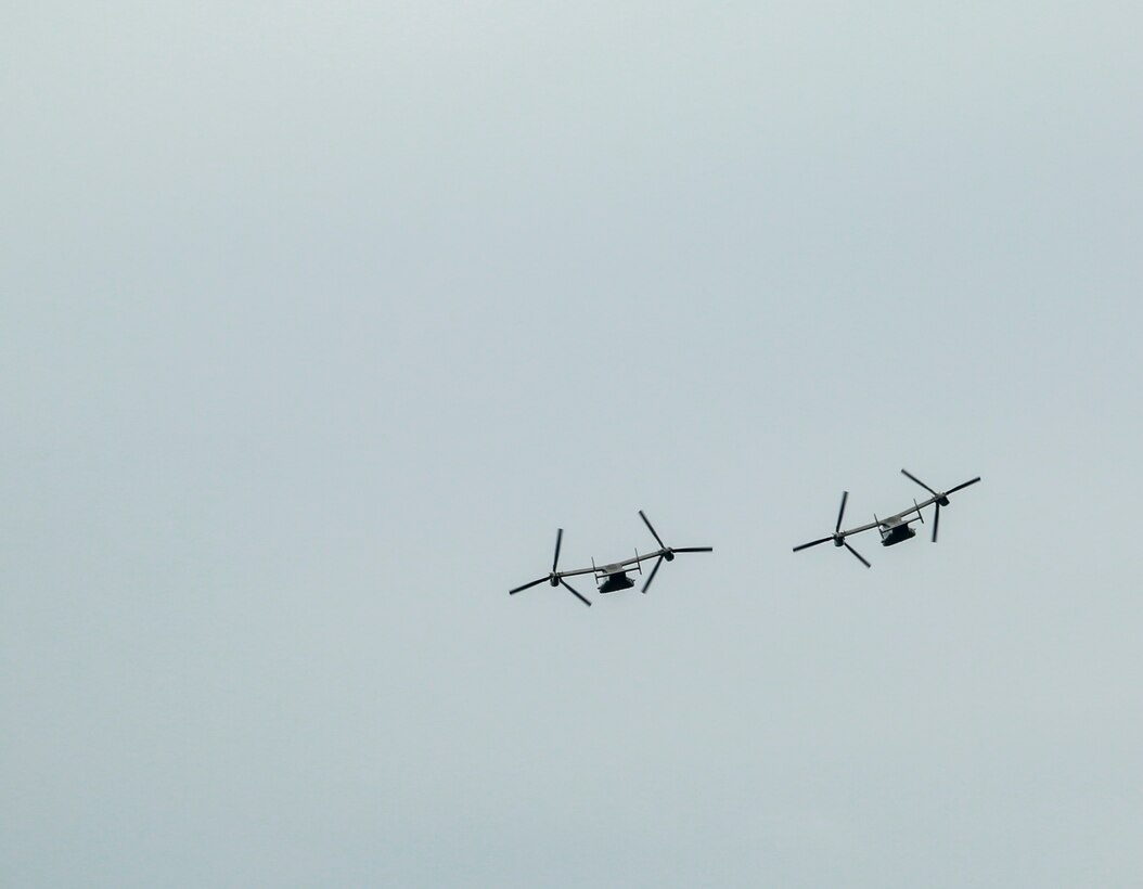 A pair of MV-22 Osprey tiltrotor aircrafts conduct a fly-over during a full honors funeral for three formerly unaccounted for Vietnam veterans at Arlington National Cemetery, Arlington, Va., Sept. 27, 2018. Capt. John A. House II, Cpl. Glyn L. Runnels, Jr. and Lance Cpl. John D. Killen III were accounted for on Dec. 22, 2015 and buried together in Arlington. The Marines died when their CH-64A Sea Knight helicopter was struck by enemy fire and crashed, June 30, 1967. House, who piloted the helicopter, was attempting to insert eight members of Company A, 3rd Reconnaissance Battalion, 3rd Marine Division, into hostile territory in Thau Thien-Hue Province, Vietnam, when enemy forces attacked from a surrounding tree line. Lance Cpl. Merlin R. Allen and Navy Hospital Corpsman Michael B. Judd also died during the crash and were individually identified in 2013. (U.S. Marine Corps photo by Sgt. Robert Knapp/Released)