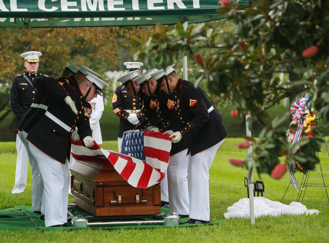Marine Corps Body Bearers, Bravo Company, Marine Barracks Washington D.C., prepare to fold the National Flag during a full honors funeral for three formerly unaccounted for Vietnam veterans at Arlington National Cemetery, Arlington, Va., Sept. 27, 2018.