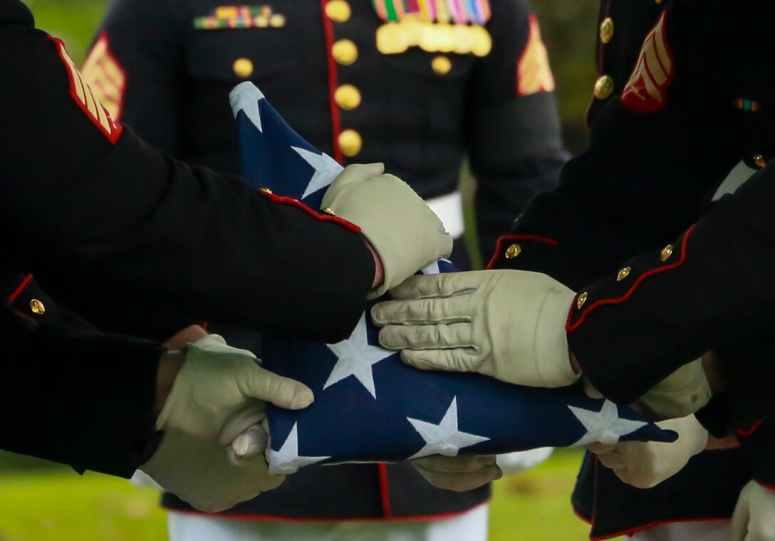 Marine Corps Body Bearers, Bravo Company, Marine Barracks Washington D.C., fold the National Flag during a full honors funeral for three formerly unaccounted for Vietnam veterans at Arlington National Cemetery, Arlington, Va., Sept. 27, 2018. Capt. John A. House II, Cpl. Glyn L. Runnels, Jr. and Lance Cpl. John D. Killen III were accounted for on Dec. 22, 2015 and buried together in Arlington. The Marines died when their CH-64A Sea Knight helicopter was struck by enemy fire and crashed, June 30, 1967. House, who piloted the helicopter, was attempting to insert eight members of Company A, 3rd Reconnaissance Battalion, 3rd Marine Division, into hostile territory in Thau Thien-Hue Province, Vietnam, when enemy forces attacked from a surrounding tree line. Lance Cpl. Merlin R. Allen and Navy Hospital Corpsman Michael B. Judd also died during the crash and were individually identified in 2013. (U.S. Marine Corps photo by Sgt. Robert Knapp/Released)