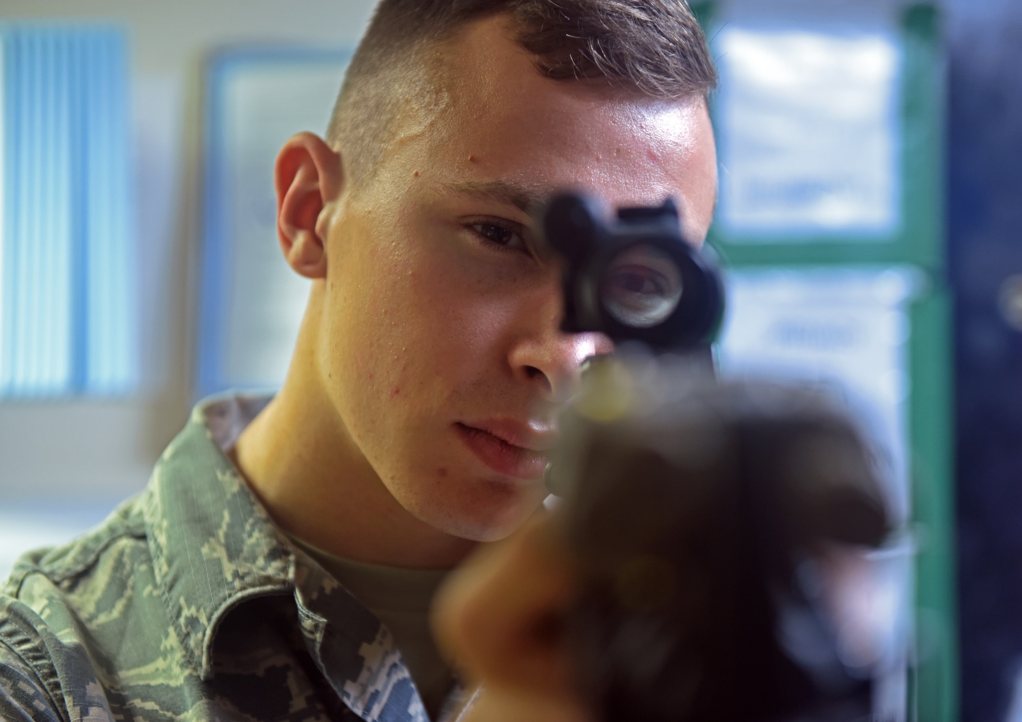 U.S. Air Force Airman 1st Class Nicholas Terry, 100th Security Forces Squadron armorer, checks the sights on an M-4 carbine rifle at RAF Mildenhall, England, Sept. 25, 2018. Airmen assigned to the armory are responsible for arming and de-arming security forces Airmen during each shift change, as well as ensuring issued weapons are being cleaned properly. (U.S. Air Force photo by Airman 1st Class Brandon Esau)