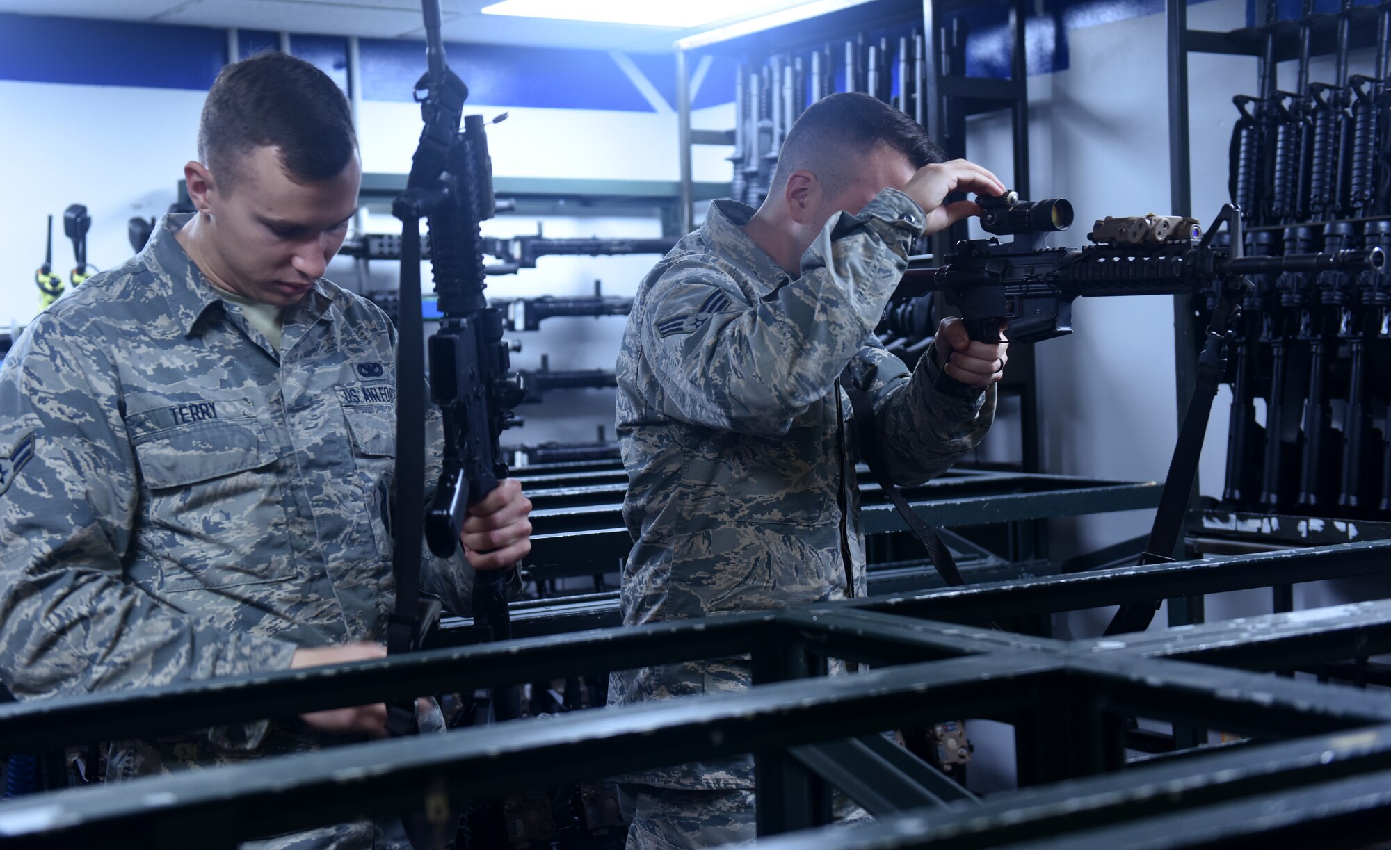U.S. Air Force Airman 1st Class Nicholas Terry, left, 100th Security Forces Squadron armorer, and Senior Airman Robert Downs, 100th SFS armory assistant NCO-in-charge, look over an M-4 carbine rifles at RAF Mildenhall, England, Sept. 27, 2018. The armory houses various weapons and ammo to include M-9 pistols, M-4 carbine rifles, M-203 grenade launchers, M-240B and M-249 machine guns. (U.S. Air Force photo by Airman 1st Class Brandon Esau)