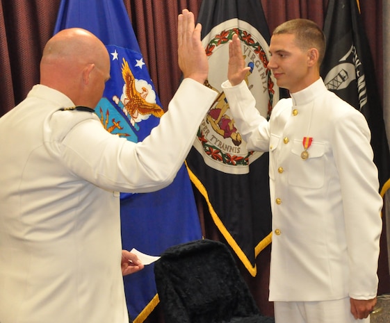 IMAGE: DAHLGREN, Va. (Sept. 21, 2018) – U.S. Navy Capt. Andrew Thomson administers the oath of office to Dillard Patton during Patton’s Naval officer commissioning ceremony at the Aegis Training and Readiness Center. Once the NSWC Dahlgren Division System Safety Engineering Division civilian engineer pledged the oath of office, he was commissioned into the officer ranks of the Naval Reserves.