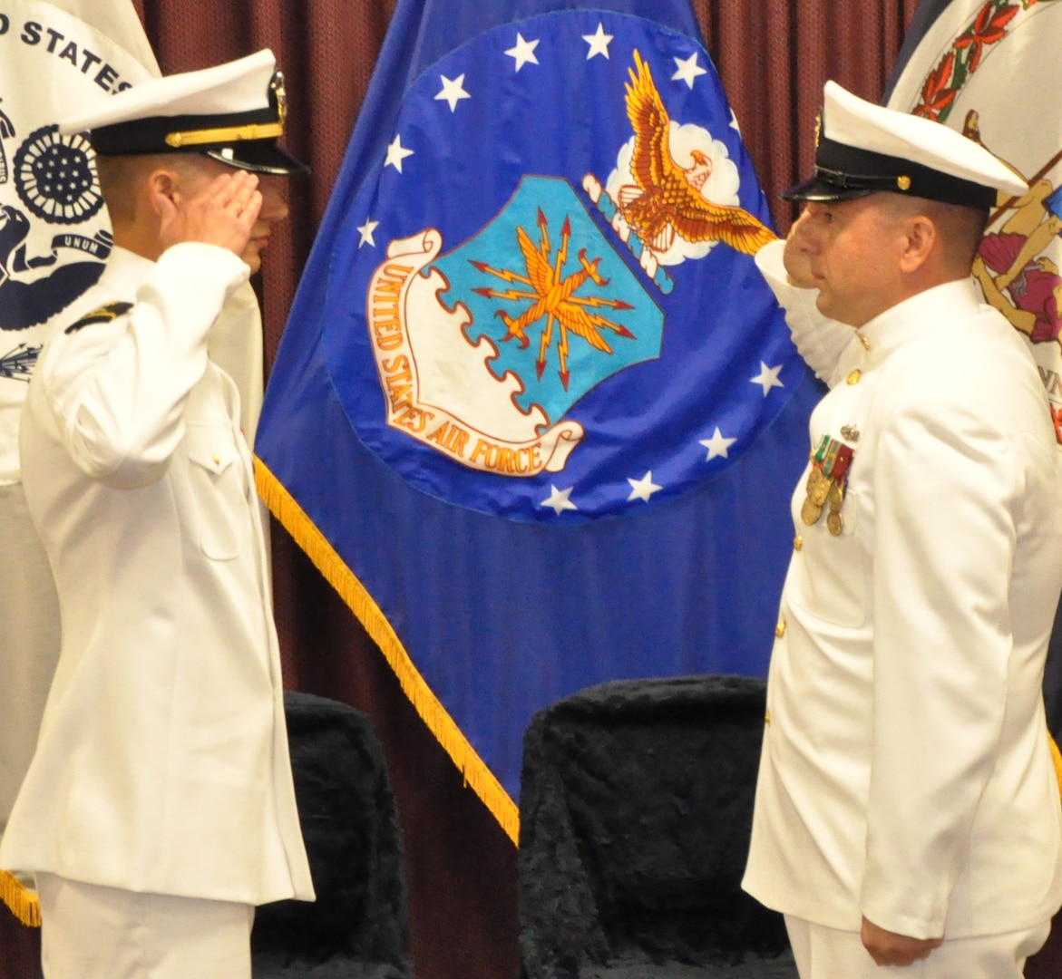 IMAGE: DAHLGREN, Va. (Sept. 11, 2018) – Senior Chief Fire Controlman Jeremy Brown (ret.) renders the first enlisted salute to U.S. Navy Ensign Dillard Patton who returns the salute at his commissioning ceremony held at the Aegis Training and Readiness Center. In accordance with tradition, Patton - an NSWCDD System Safety Engineering Division civilian engineer - presented a brand new silver dollar to Brown as the first enlisted service member who saluted him. Upon receiving the silver dollar, Brown saluted and Patton returned the salute again.