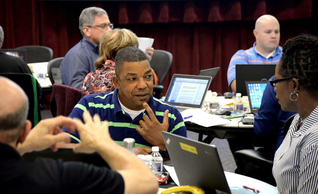 Robert A. Jones, center, an auditor with the U.S. Army Space and Missile Defense Command / Army Forces Strategic Command, debates some auditing nuances with Teresa Pender, right, an auditor with Defense Finance and Accounting Services, Sept. 12 during a four-day government auditing foundational course led by the Internal Review team at the U.S. Army Engineering and Support Center, Huntsville, at the nearby Bevill Center. (U.S. Army photo by Stephen Baack, Huntsville Center Public Affairs)