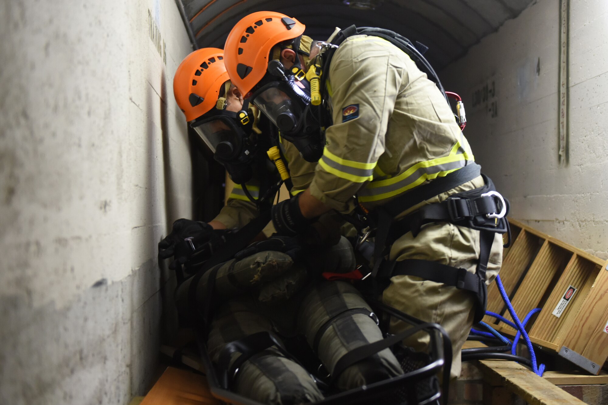 48th Civil Engineer Squadron firefighters simulate recovering a patient during a confined space training exercise Royal Air force Lakenheath, England, Sept. 24. Confined-space rescue becomes necessary when someone becomes trapped in areas such as tanks, vaults and tunnels. (U.S. Air Force photo/ Christopher S. Sparks)