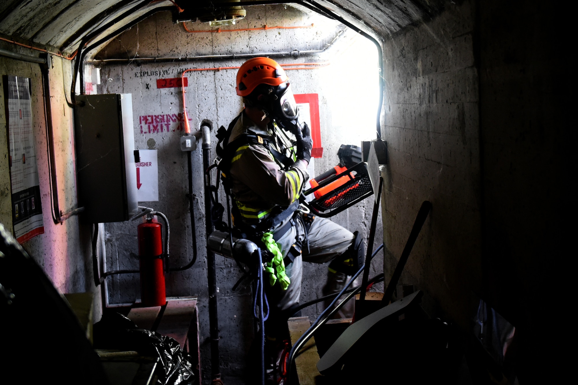 A 48th Civil Engineer Squadron Airman exits a bunker with a simulated patient during a confined space training exercise Royal Air force Lakenheath, England, Sept. 24. RAF Lakenheath has more than 100 different confined spaces on base the 48th CES Airmen may potentially respond to if an emergency situation requires it. (U.S. Air Force photo/ Christopher S. Sparks)