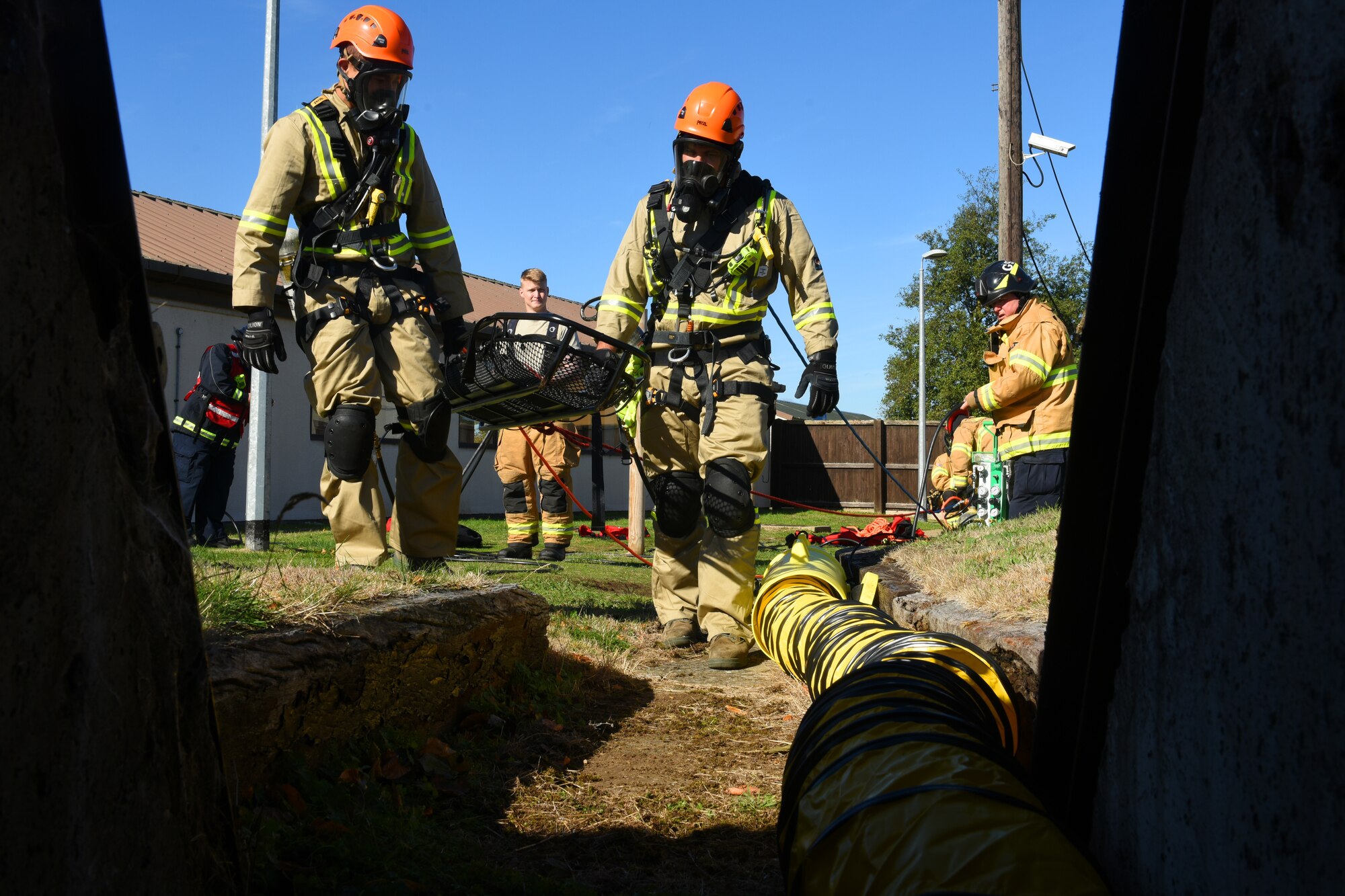 48th Civil Engineer Squadron firefighters enter a bunker during a confined space training exercise Royal Air force Lakenheath, England, Sept. 24. The exercise hones the skills of seasoned firefighters, and expands the skillset of inbound 48th CES fire department Airmen. (U.S. Air Force photo/ Christopher S. Sparks)