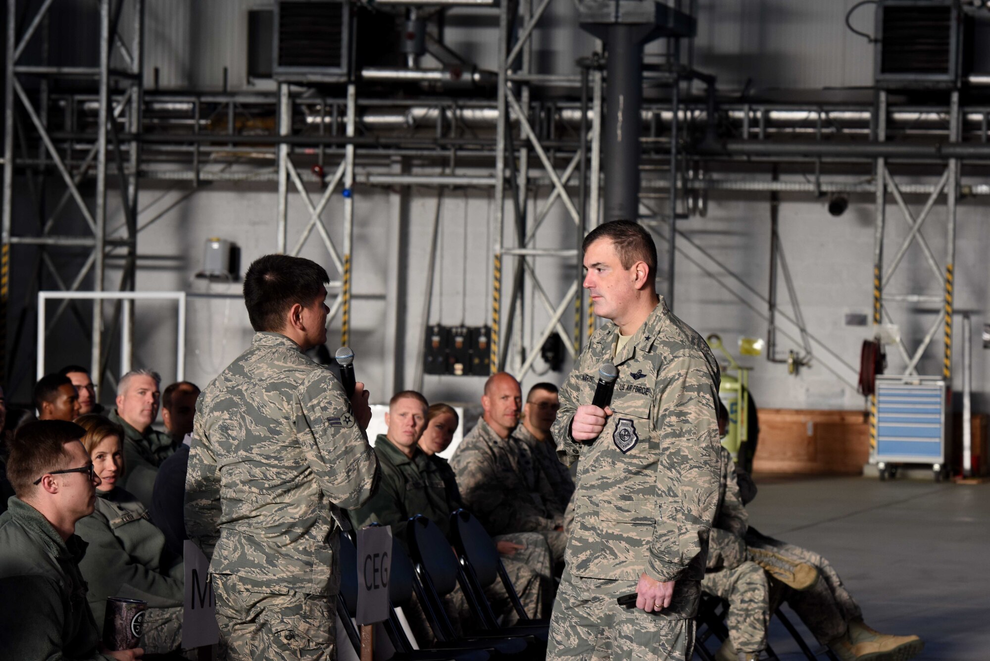Brig. Gen. Mark August, 86th Airlift Wing commander, listens to a question from an Airmen at an all call on Ramstein Air Base, Germany, Sept. 27, 2018. August asked Airmen to voice their concerns and gave feedback on his vision and intent.