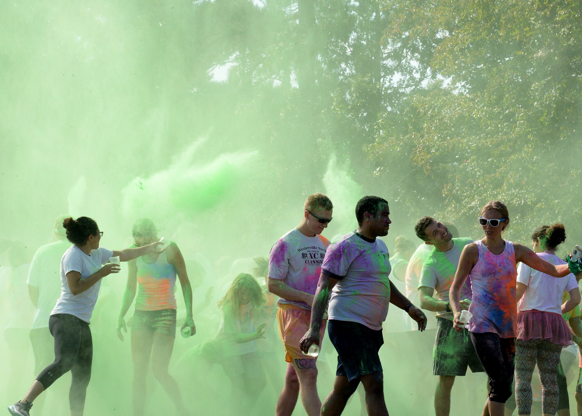 Participants walk away covered in a rainbow of color after the sixth annual color run Sept. 22, 2018, at Columbus Air Force Base, Mississippi. Over 28 volunteers helped ensure color run participants were safe and had fun. (U.S. Air Force photo by Airman Hannah Bean)