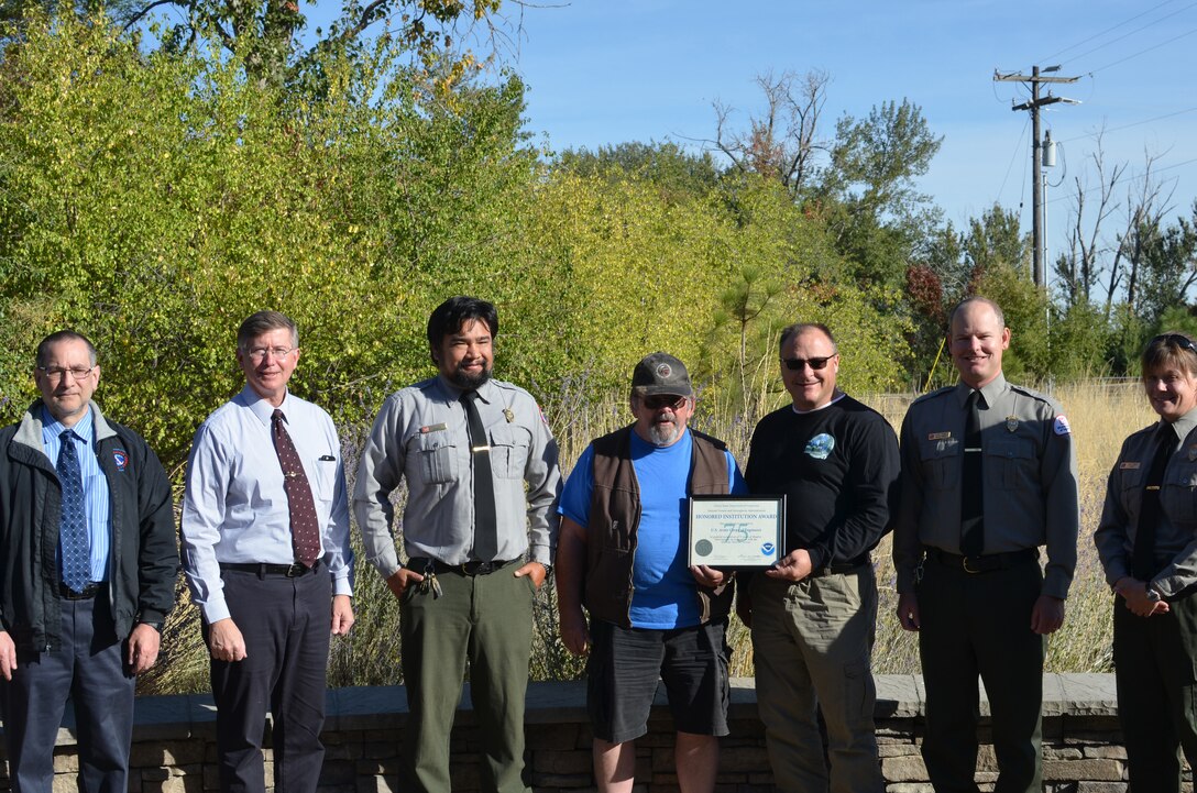 National Weather Service (NWS) officials present U.S. Army Corps of Engineers (USACE) staff at the Mill Creek Dam and Bennington Lake project with an “Honored Institution Award” on Wednesday, Sept. 26, for 75 years of service in the National Weather Service’s Cooperative Observer program. From left, Mike Vescio, NWS Pendleton Field Office meteorologist in charge; Dr. Grant Cooper, Western Region NWS Director; Jeremy Nguyen, USACE park ranger; Dave Parker, retired lead maintenance worker; Lonnie Croft, lead maintenance worker; Justin Stegall, USACE operations project manager; and Cady Tyron, USACE park ranger. Not pictured: Troy Hein, USACE maintenance worker. U.S. Army Corps of Engineers photo.