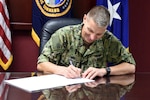 U.S. Navy Rear Adm. Richard Correll, U.S. Strategic Command (USSTRATCOM) director of plans and policy, signs an agreement to share Space Situational Awareness services and information with Netherlands at USSTRATCOM headquarters on Offutt Air Force Base, Neb., Sept. 21, 2018.