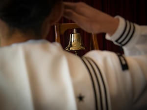 Petty Officer 2nd Class Lauren Pereda, Naval Health Clinic Charleston hospital corpsman, salutes during the national anthem at the Bells Across America memorial ceremony Sept. 27, 2018, at Joint Base Charleston, S.C. The ceremony is an annual U.S. military tradition held across the country to honor and commemorate fallen service members. During the ceremony, a bell is rung after each service member’s name is read.