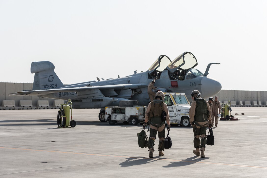 Marines deployed with Marine Tactical Electronic Warfare Squadron 2 step to their EA-6B Prowler at Al Udeid Air Base, Qatar, Sept. 12, 2018. VMAQ-2 is currently completing the final EA-6B Prowler deployment before the last six aircraft in the U.S. military inventory are retired. (U.S. Air Force photo by Tech. Sgt. Ted Nichols/Released)