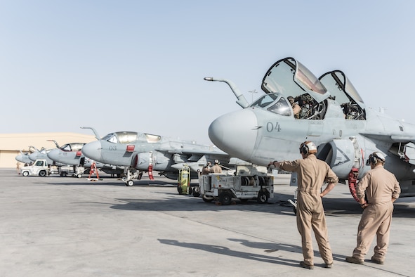 Marines deployed with Marine Tactical Electronic Warfare Squadron 2 step to their EA-6B Prowler at Al Udeid Air Base, Qatar, Sept. 12, 2018. VMAQ-2 is currently completing the final EA-6B Prowler deployment before the last six aircraft in the U.S. military inventory are retired. (U.S. Air Force photo by Tech. Sgt. Ted Nichols/Released)