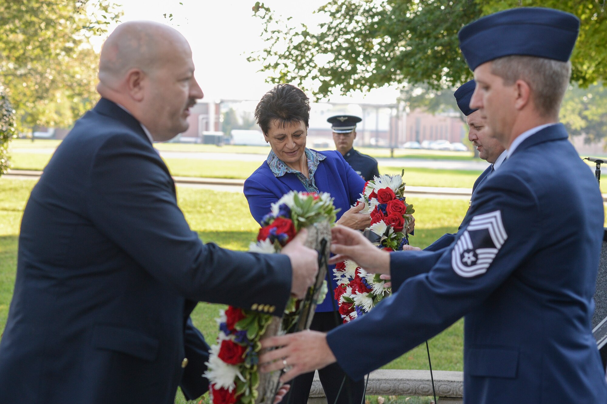 Retired Air Force Col. Cassie Barlow, president of the Miami Valley Military Affairs Association, and Retired Senior Master Sgt. David McCoy, president of Chapter 751 of the Air Force Sergeants Association, lay wreaths at the POW/MIA Recognition Day Memorial at the Arnold House during a ceremony at Wright-Patterson Air Force Base Sept. 21. (U.S. Air Force photo/Wesley Farnsworth)