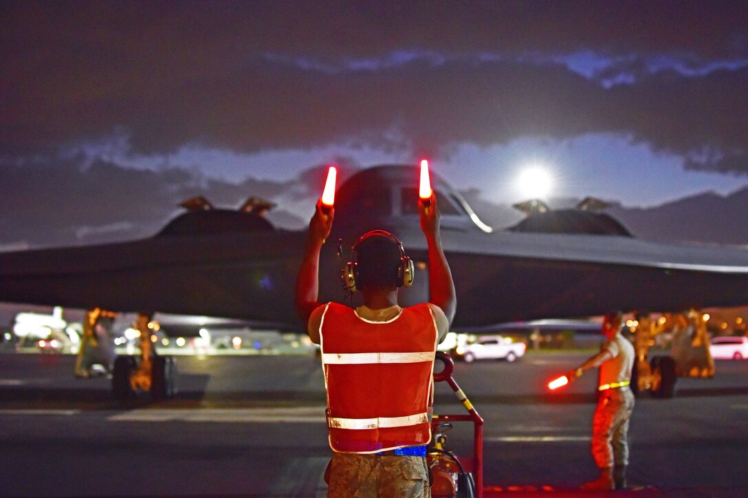 Airman 1st Class Christopher Rucker, a crew chief assigned to the 509th Aircraft Maintenance Squadron, marshals a B-2 Spirit returning from a routine training mission at Joint Base Pearl Harbor-Hickam, Hawaii, Sept. 6, 2018. The B-2s deployed to JBPH-H from Whiteman Air Force Base, Mo., in support of the U.S. Strategic Command’s Bomber Task Force deployment. USSTRATCOM regularly tests and evaluates the readiness of strategic assets to ensure they can honor U.S. security commitments. (U.S. Air Force photo by Staff Sgt. Danielle Quilla)