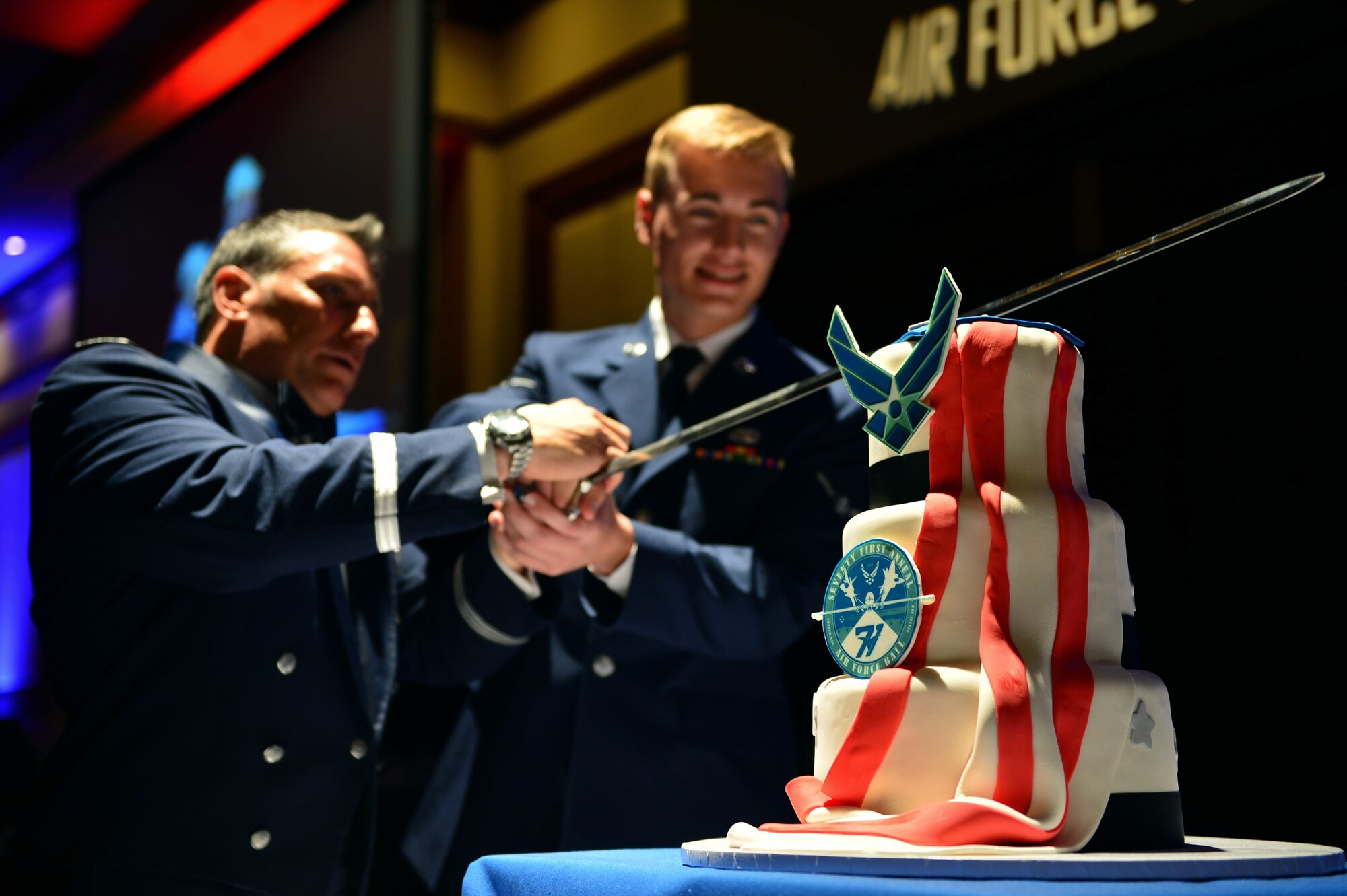 Brig. Gen. Craig Baker, 12th Air Force vice commander, and Airman 1st Class Philip, the youngest Airman in attendance, cut a ceremonial cake at the 2018 Las Vegas Air Force Ball, Sept. 15, 2018. It is tradition for the highest ranking and youngest Airmen to cut the ceremonial cake at formal Air Force events. Editor’s note: Airman 1st Class Philip’s last name was removed for operational security purposes by request of the 432nd Wing. (U.S. Air Force photo by Airman 1st Class Haley Stevens)