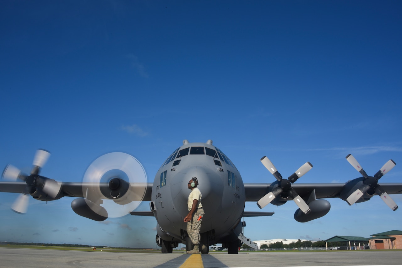 Crew chief prepares C-130 for takeoff.