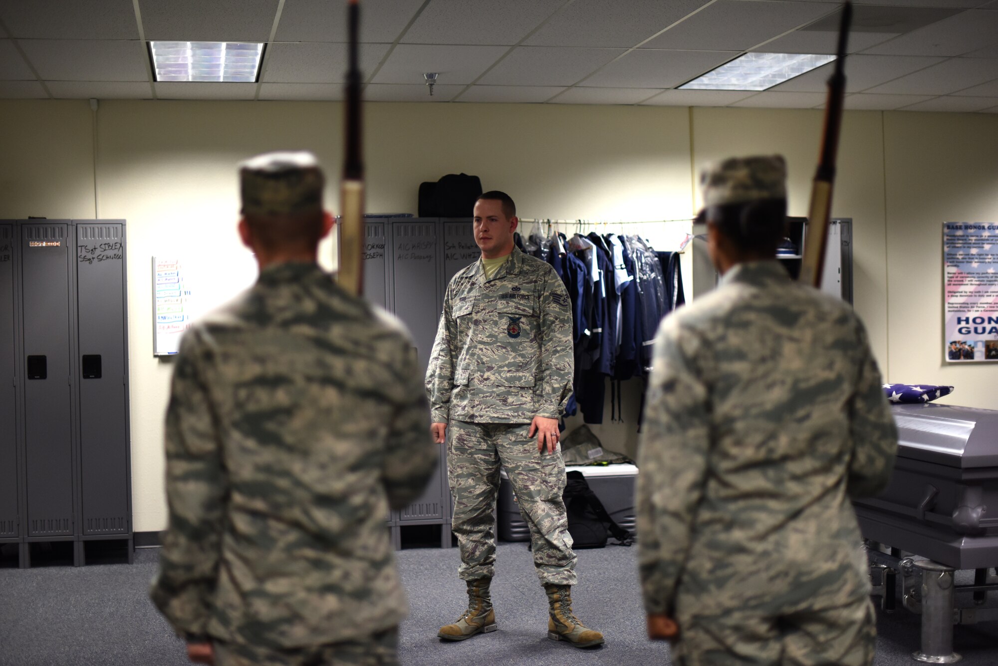 U.S. Air Force Staff Sgt. Jonathan Kidd, noncommissioned officer in charge of the Goodfellow Honor Guard, watches members while calling maneuvers to catch if someone incorrectly executes a movement during training in the honor guard practice room on Goodfellow Air Force Base, Texas, Sept. 21, 2018. Kidd will sometimes use this game to see who will go out to perform details when asked. (U.S. Air Force photo by Airman 1st Class Seraiah Hines/Released)