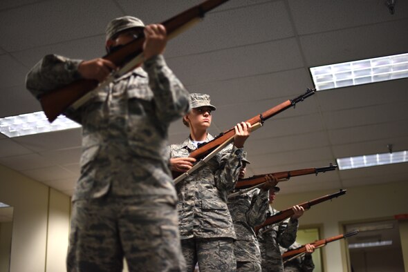 Members of the Goodfellow Honor Guard train by participating in a game of elimination in the honor guard practice room on Goodfellow Air Force Base, Texas, Sept. 21, 2018. Maneuvers are called and if incorrectly executed that member is eliminated, the last person to correctly execute all the movements wins. (U.S. Air Force photo by Airman 1st Class Seraiah Hines/Released)