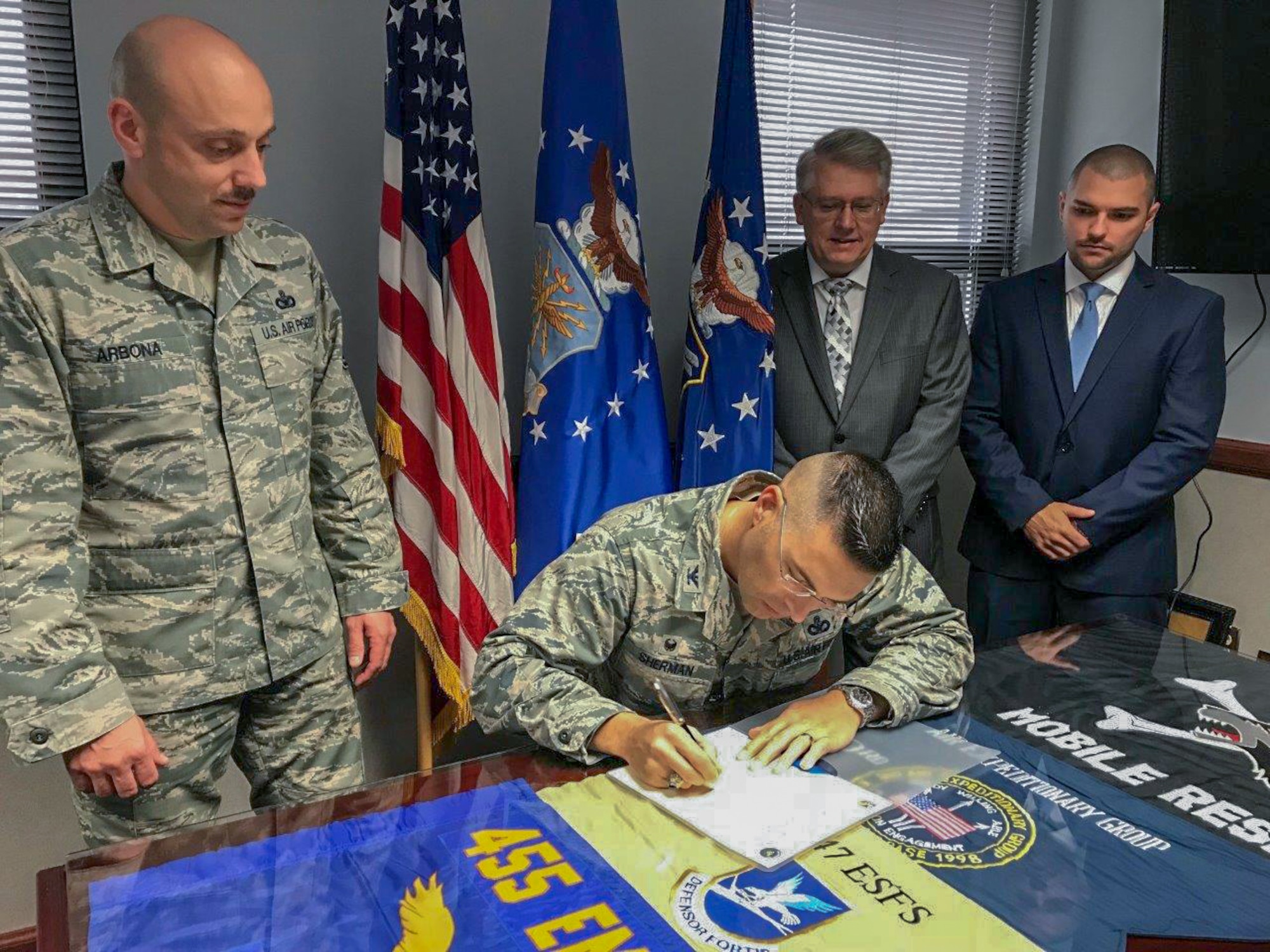 Col. Thomas Sherman, 88th Air Base Wing and Installation commander, signs a proclaimation to declare October 2018 as Wright-Patterson Air Force Base Energy Action Month