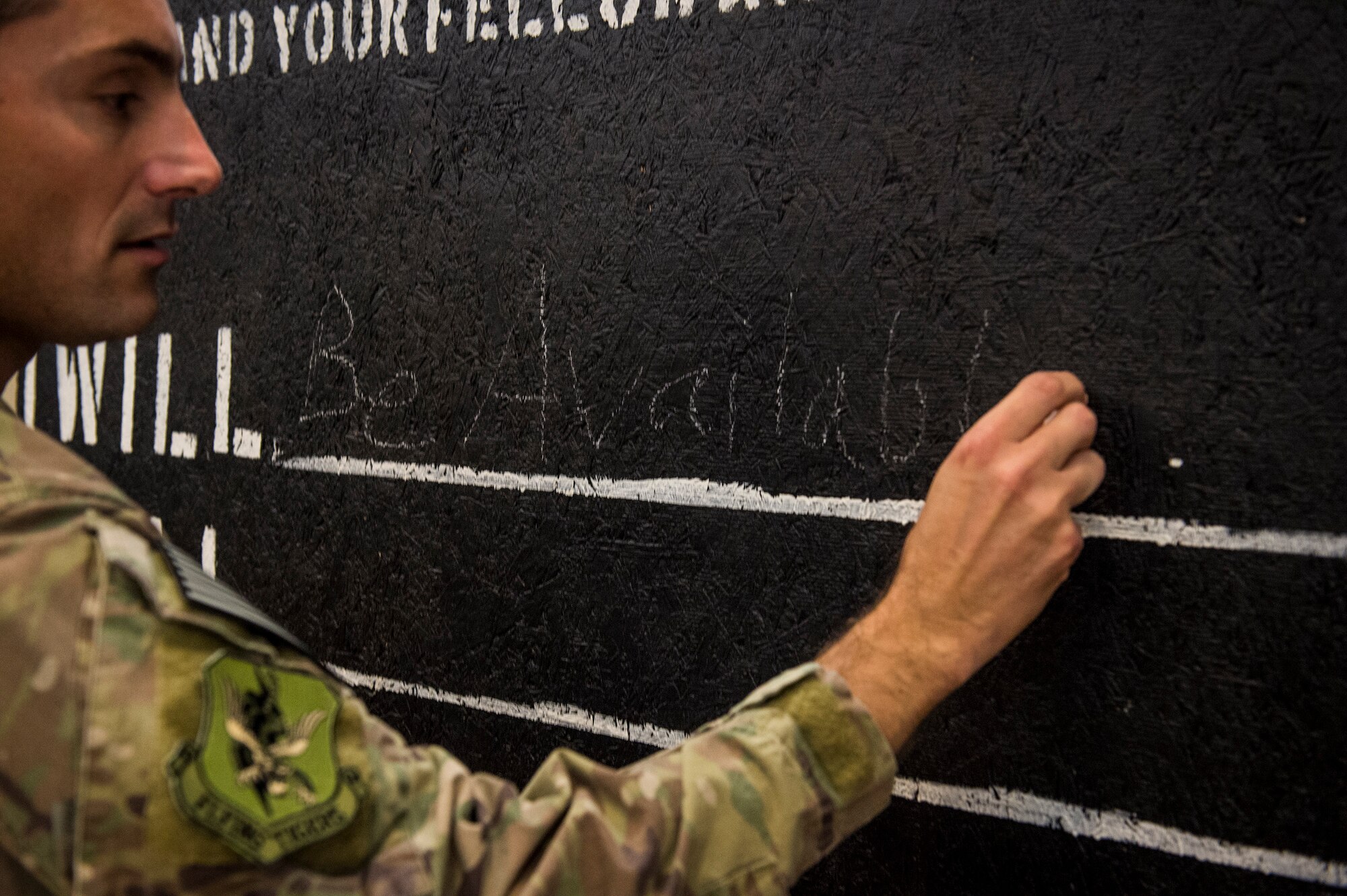 Col. Justin Demarco, 23d Wing vice commander, signs the Green Dot Commitment Board during the Comprehensive Airmen and Fitness Day, Sept. Moody Air Force Base, Ga. The board was crafted for Airmen and by Airmen and will travel across the base and Airmen will write down their commitments. Green Dot is an Air Force program designed to reinforce the key principles of prevention that can be applied to many issues such as sexual assault, suicide prevention, domestic violence, stalking and child abuse prevention.
