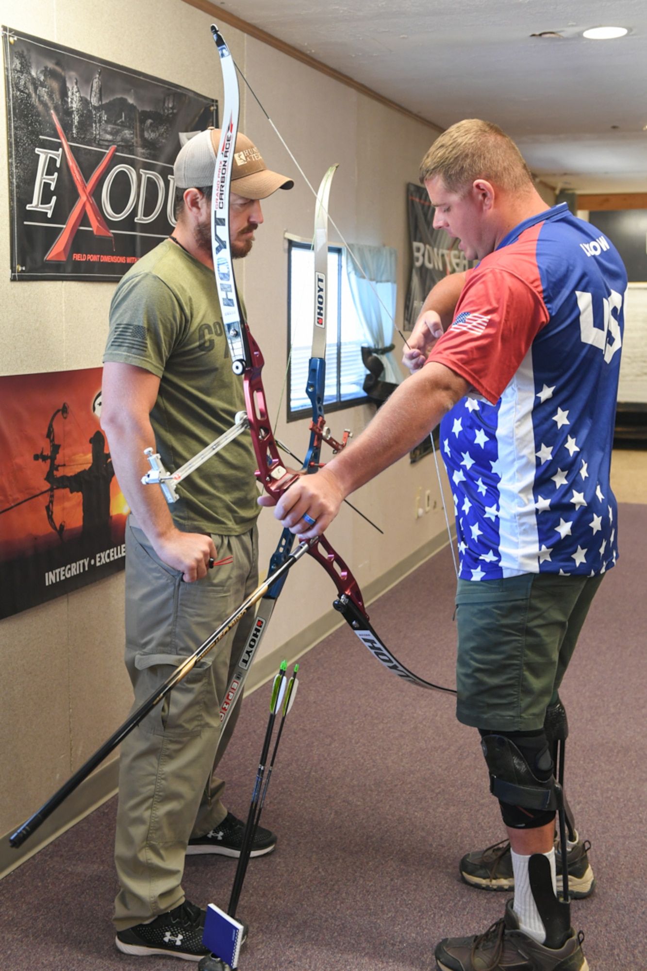 Army Staff. Sgt. Michael Lukow, from the U.S. Paralympic Archery team and still active duty with the Army’s World Class Athlete Program, guides Marine Staff Sgt. James Dunaway from Mission Valley, Calif., with his grip on the recurve bow during a Paralympic Archery Training Camp Sept. 25, 2018, at Hill Air Force Base, Utah. Hill hosted the camp Sept. 24-28 through the Paralympic Military Program, which is run by the United States Olympic Committee in partnership with the U.S. Department of Defense and U.S. Department of Veterans Affairs. (U.S. Air Force photo by Cynthia Griggs)
