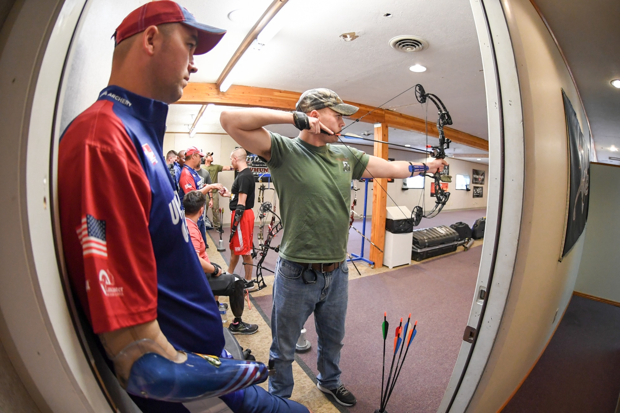 Marine Lance Cpl. Ian Stairwalt from Wounded Warrior Battalion West at Camp Pendleton, Calif., aims his compound bow while Lance Thornton, a member of the U.S. Paralympic Archery Team, watches his technique Sept. 25, 2018, at Hill Air Force Base, Utah. Hill hosted the camp Sept. 24-28 through the Paralympic Military Program, which is run by the United States Olympic Committee in partnership with the U.S. Department of Defense and U.S. Department of Veterans Affairs. (U.S. Air Force photo by Cynthia Griggs)