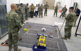 Capt. Joseph Waters, 831st Transportation Battalion, Qatar Detachment Commander conducts a rehearsal of concept (ROC) drill with soldiers, prior to the start of their quarterly mission conducted at the Port of Mesaieed in Qatar on Sept. 23. (U.S. Army photo by: Sgt. 1st Class Lisa Rodriguez Presley, 143rd ESC Public Affairs)