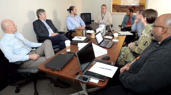 Vernon Petty, fourth from left, project manager for costs with the Center of Standardization at Huntsville Center, and Tiffany Torres, fifth from left, Value Engineering officer and value program manager, help facilitate a Value Engineering workshop in March with members of the Army Center for Initial Military Training in March at Huntsville Center to examine the Army’s proposed Soldier Physical Readiness Centers.