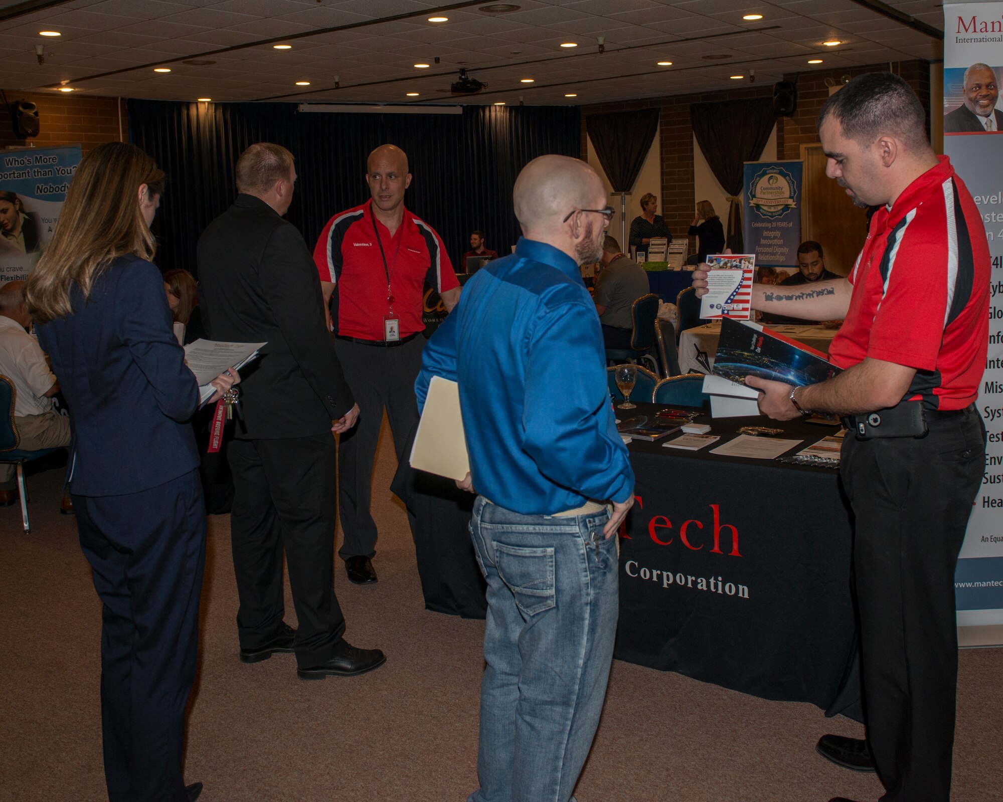 Attendees talk with employers participating in the Airmen and Family Readiness Center spouses job fair, September 25, 2018, at Mountain Home Air Force Base, Idaho. The spouses job fair featured 23 different employers offering positions to Mountain Home AFB personnel and civilians. (U.S. Air Force Photo by Airman 1st Class JaNae Capuno)