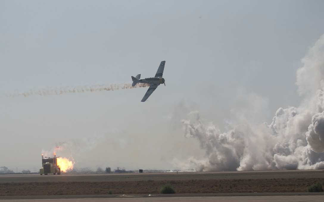 The Shockwave Jet Truck races an AT-6 Texan "War Dog" across the flight line during the 2017 Marine Corps Air Station Miramar Air Show at MCAS Miramar, Calif., Sept. 28.This year’s air show honors “100 years of women in the Marine Corps” by featuring several performances and displays that highlight

Accomplishments and milestones women since the first female enlistee, Opha May Johnson, who joined the service in 1918. (U.S. Marine Corps photo by LCpl Raynaldo D. Ramos)