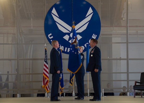 Maj. Gen. Andrew A. Croft, (left) 12th Air Force commander, and Mj. Gen. Patricj Doherty, (right) 19th Air Force commander, roll the Air Combat Command flag on Sept. 28, in hangar 301 on Holloman Air Force Base, N.M. The commanders rolled the ACC flag so the Air Education and Training Command flag could be unfurled. (U.S. Air Force by Airman Autumn Vogt)