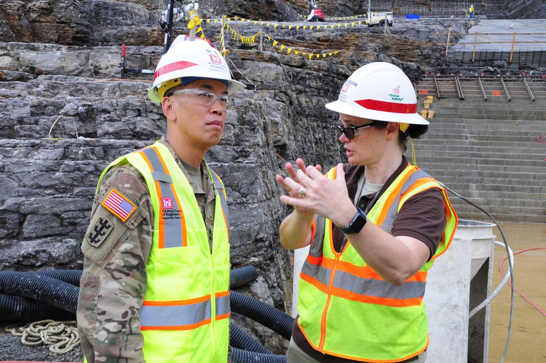 Vanessa Bateman, Nashville District Civil Design Branch chief, updates Maj. Gen. Mark Toy, Great Lakes and Ohio River Division commander, on the roller compacted concrete berm under construction near the saddle dam in Silver Point, Tenn., Sept. 27, 2018.  The saddle dam is nearby Center Hill Dam. (USACE photo by Mark Rankin)