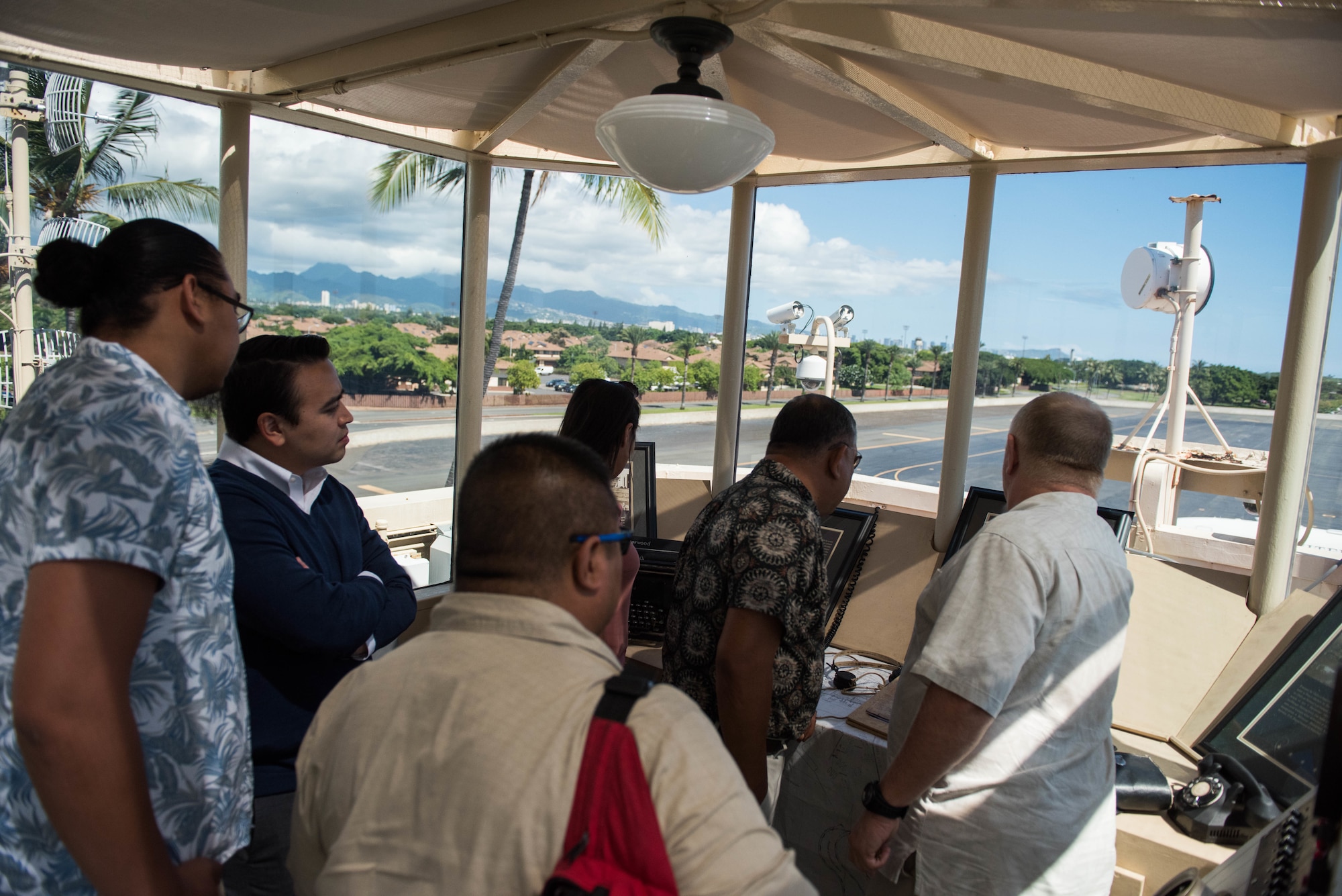 A group from the Commonwealth of the Northern Mariana Islands, the Commonwealth Port Authority, and Department of Defense civilians, contractors and service members take a tour of the old air traffic control tower on Joint Base Pearl Harbor-Hickam, Hawaii, Sept. 19, 2018.