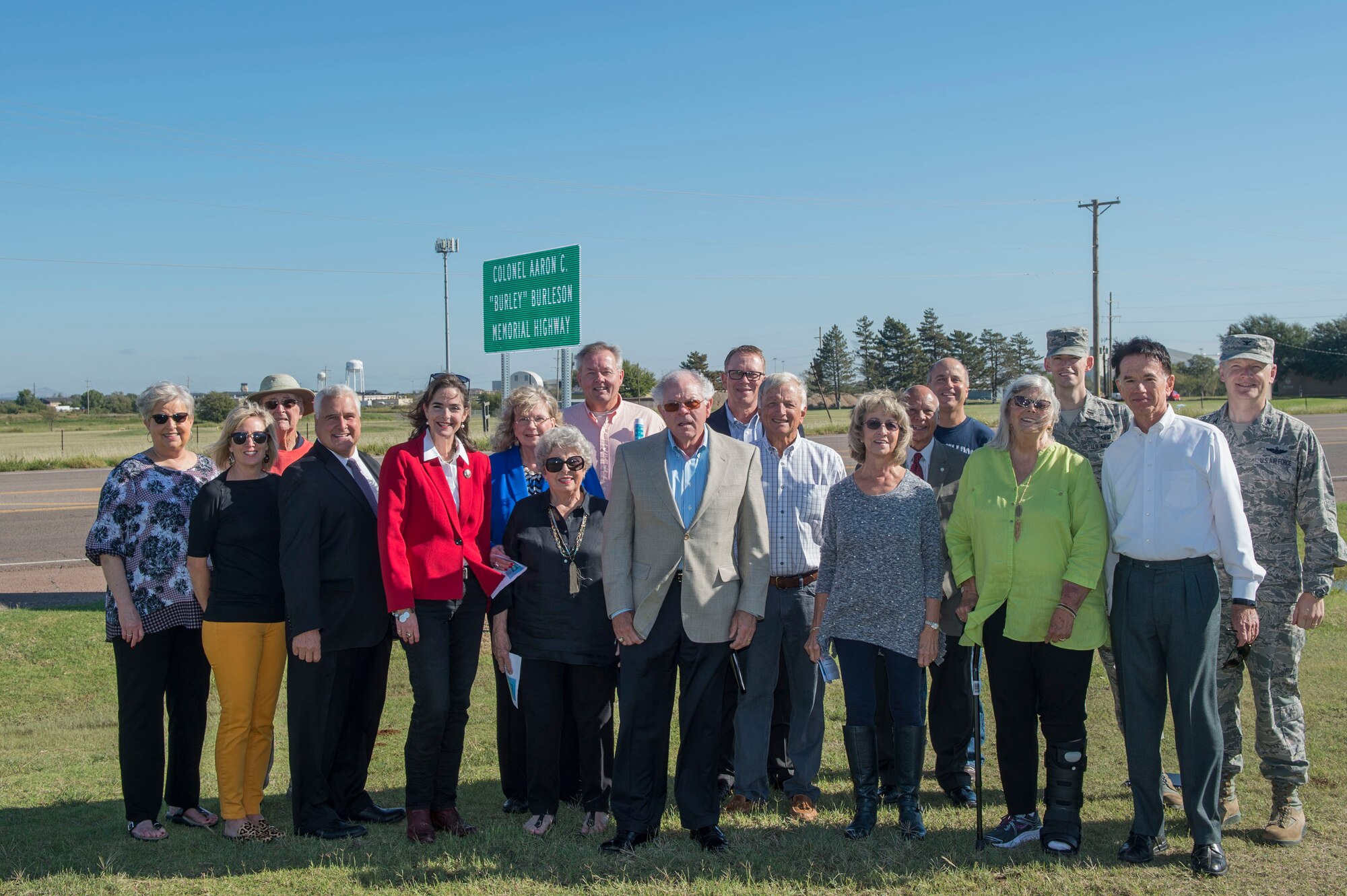 Distinguished members of the City of Altus and the State of Oklahoma stand in front of a sign dedicating the highway to late U.S. Air Force Col. (Ret.) Aaron “Burley” Burleson, former commander of the 97th Air Mobility Wing, during a sign commemoration ceremony, Sept. 28, 2018, at Altus, Okla. To honor Aaron Burleson’s achievements to the Altus community and 97th AMW, his family and members of the Oklahoma Congress came to an agreement to name part of State Highway 52 after him. (U.S. Air Force photo by Senior Airman Cody Dowell)